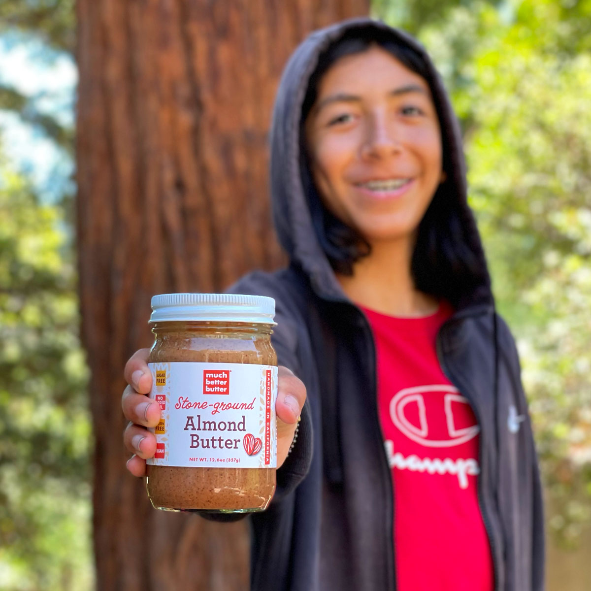 Boy holding Much Better Butter™ Almond Butter